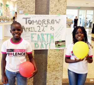 Some helpful (and cheerful) young activists at AWID who helped us make some signs for Earth Day!